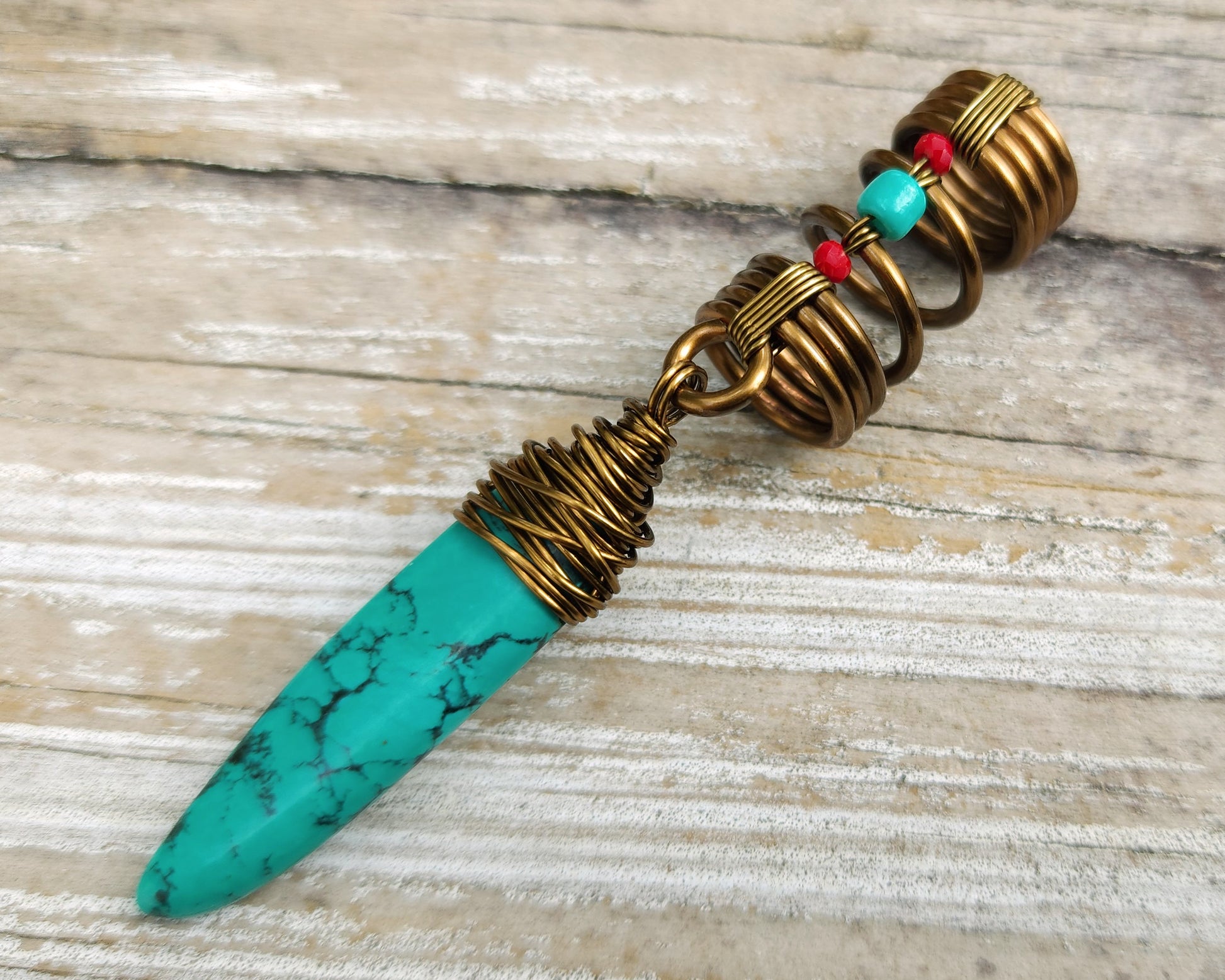 Turquoise hair jewelry on a wood background.