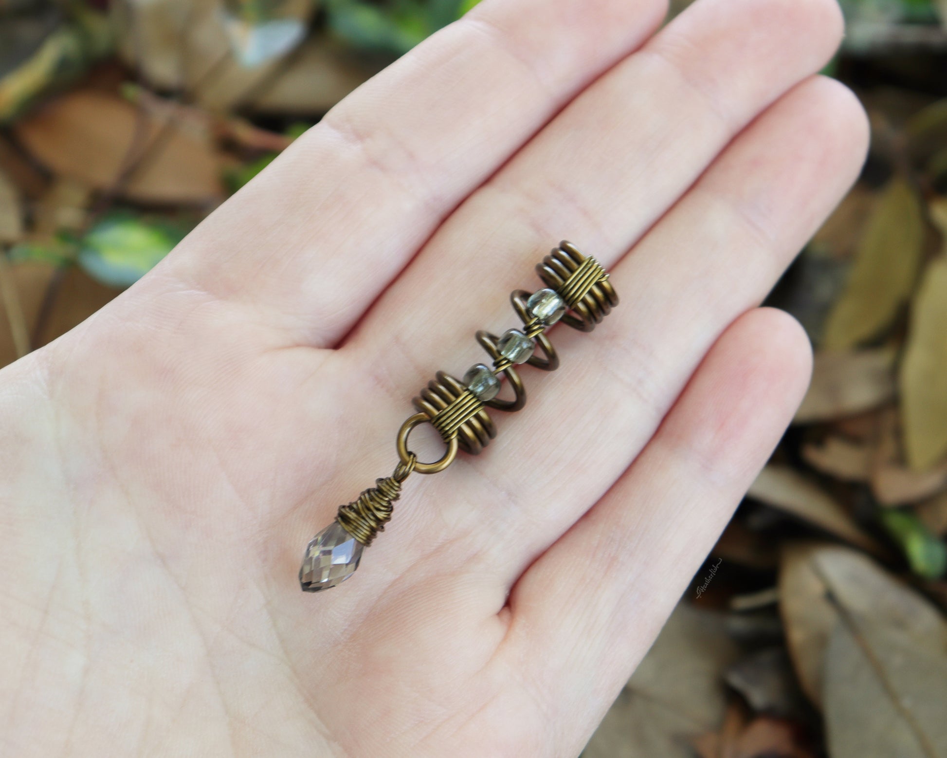 Smoky glass loc bead held in hand to show scale.