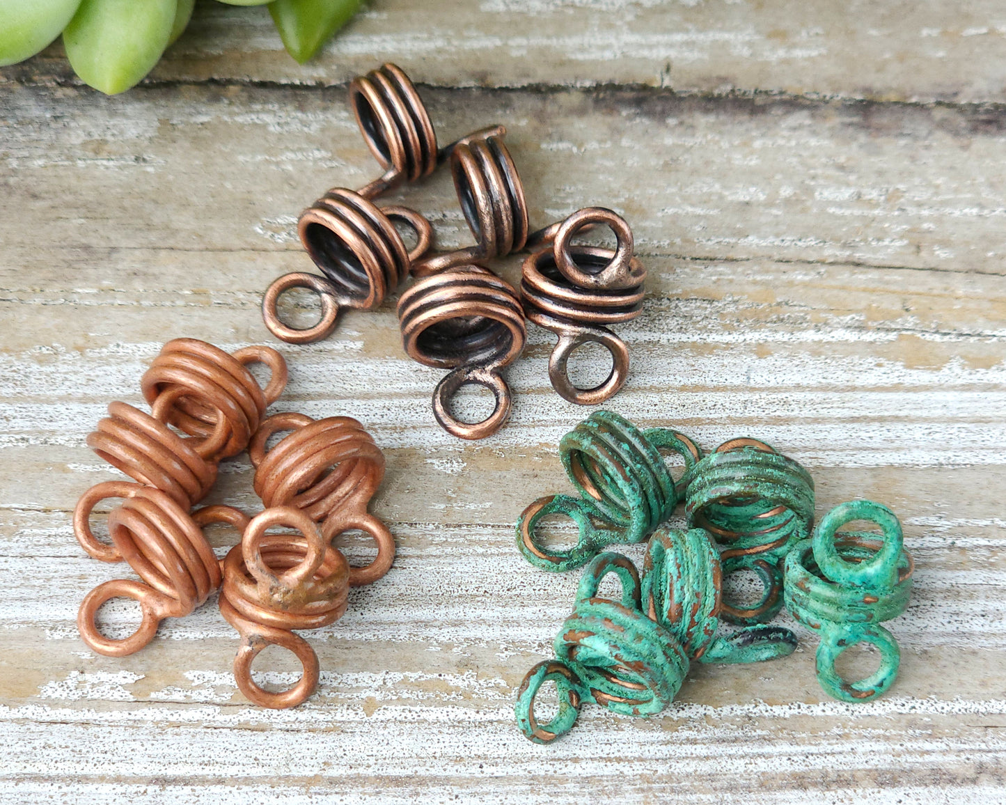 Rustic hair jewelry soldered sets of 5 in piles on a wood background to show finish options.