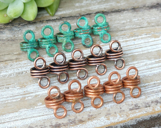 Rustic hair jewelry soldered sets of 5 lined up on a wood background to show finish options.