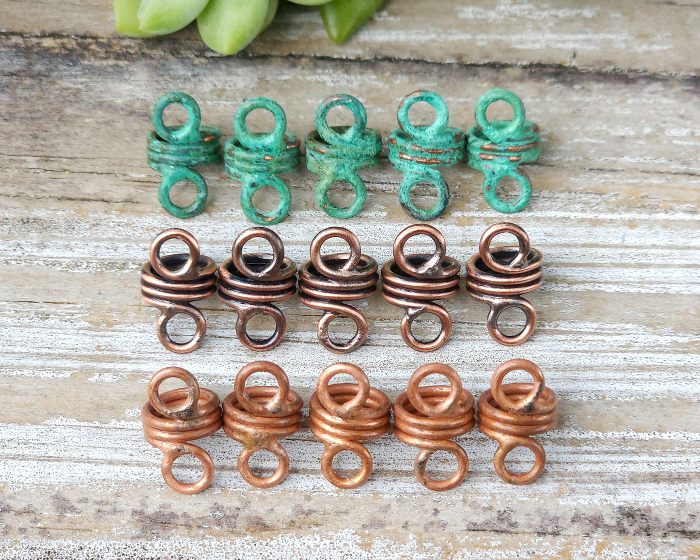 Rustic hair jewelry soldered sets of 5 lined up on a wood background to show finish options.