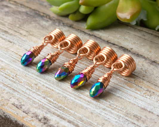 Hair jewelry aligned in a diagonal row on a wood board.