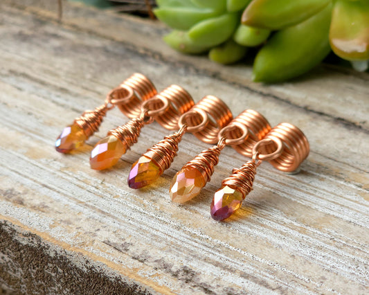 Orange iridescent loc beads, set of 5 on a wood board.