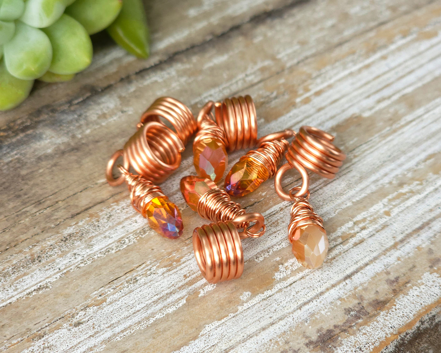 Orange iridescent loc beads, set of 5 on a wood board.