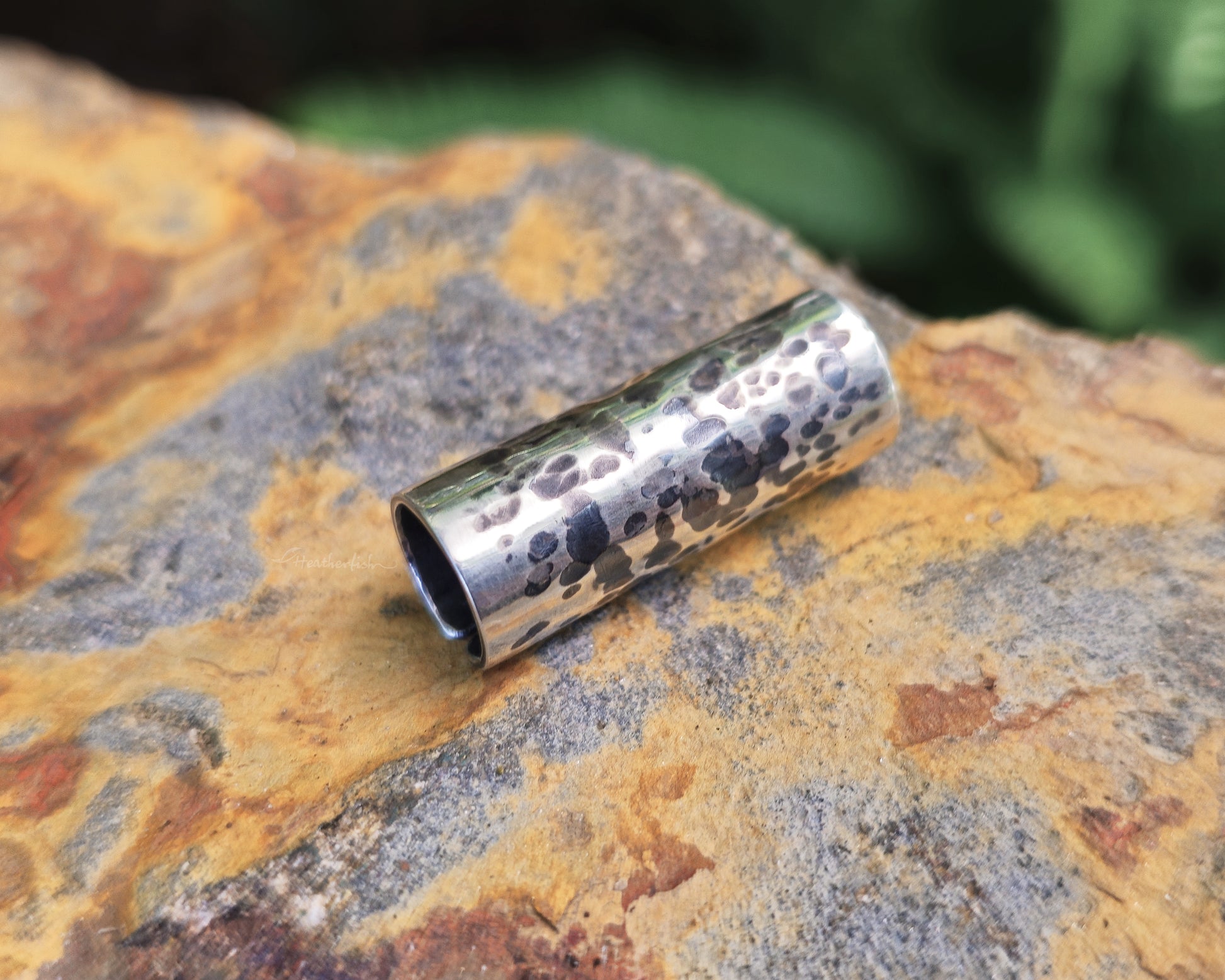 Sterling silver hair cuff on a rock.