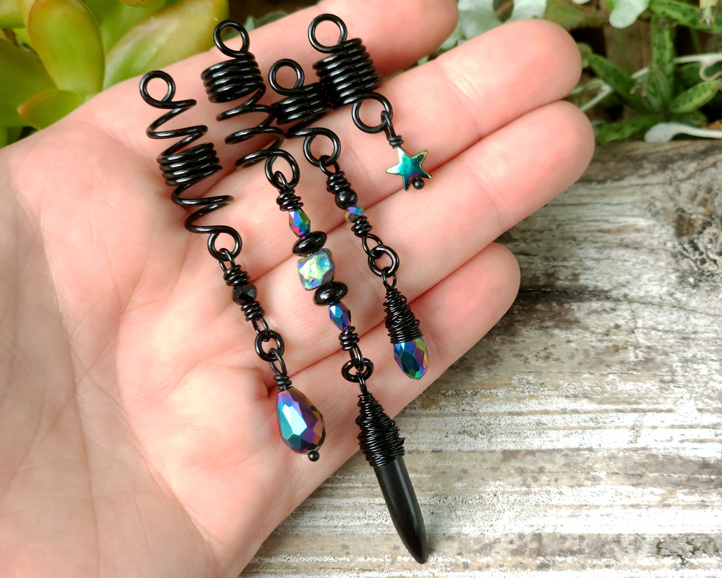 Black rainbow set of 4 dread beads held in hand to show scale.