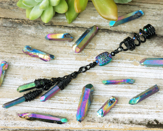 Triple rainbow titanium quartz dreadlock bead on a wood board.
