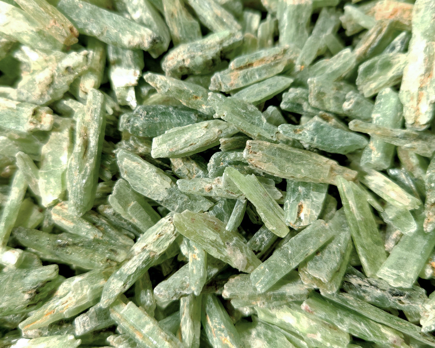 Pile of green kyanite shards.
