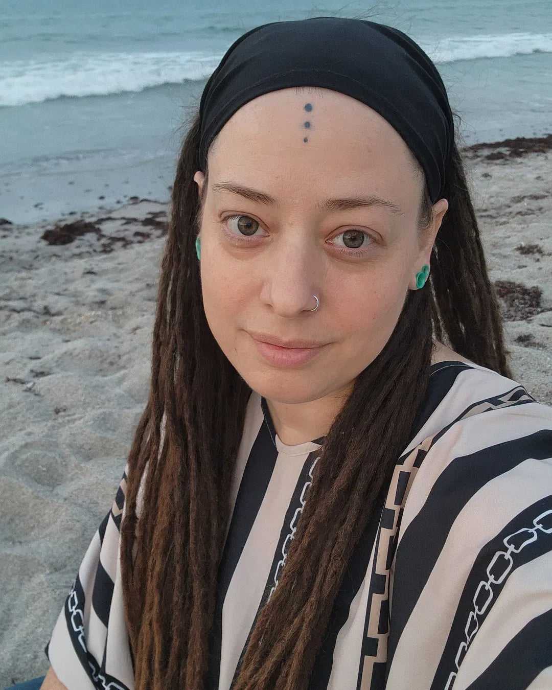 Photo of heather on a beach, artist and owner of heatherfish creations.