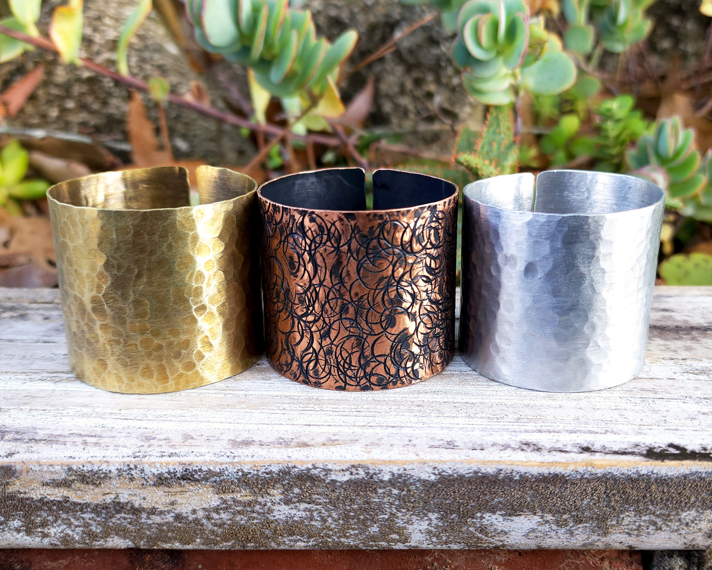 Large hair cuffs aligned on a wood background.