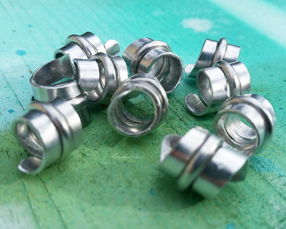 A close up side view of Stylized Aluminum Dread Beads a Set of 10.