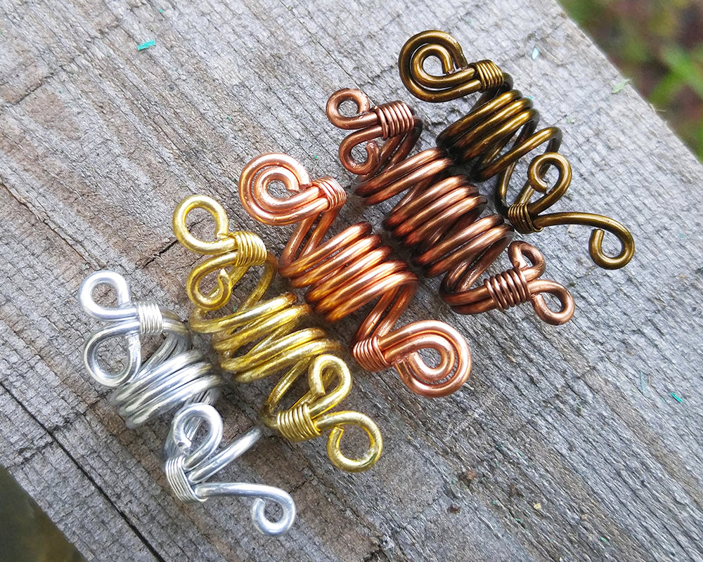 Alternative top view of a set of 5 ombre dread beads on painted wood surface.