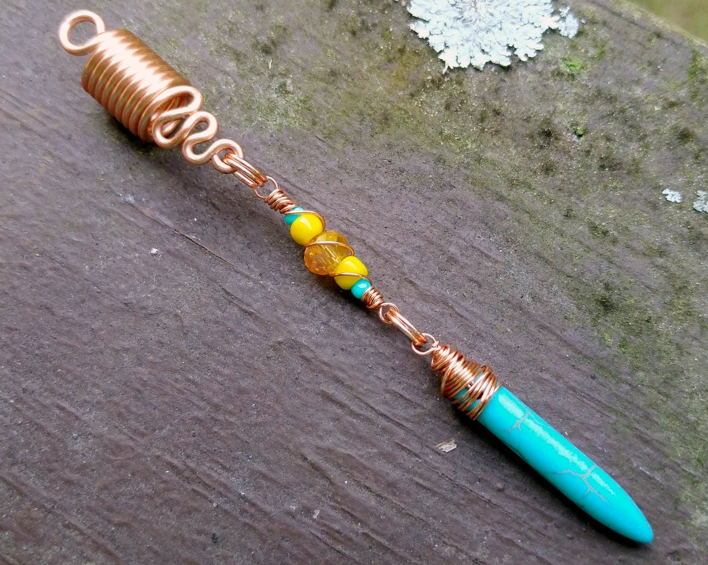 A close up view of a Turquoise Spike Dread Bead.