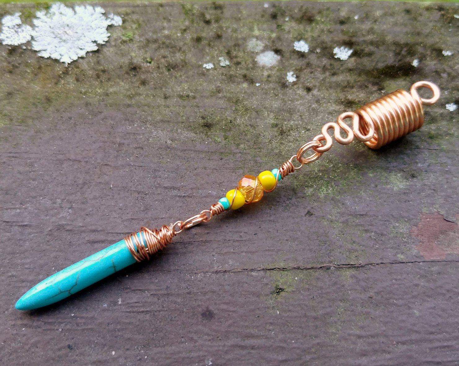 A side view of a Turquoise Spike Dread Bead.