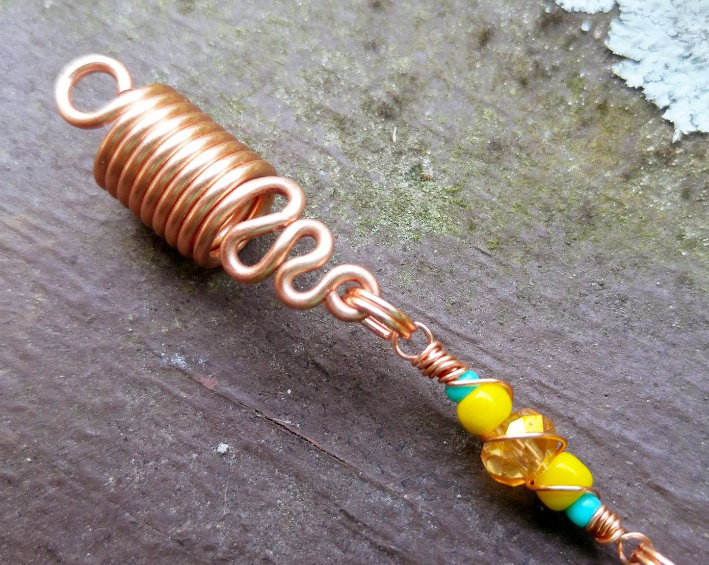 A close up view of a Turquoise Spike Dread Bead.