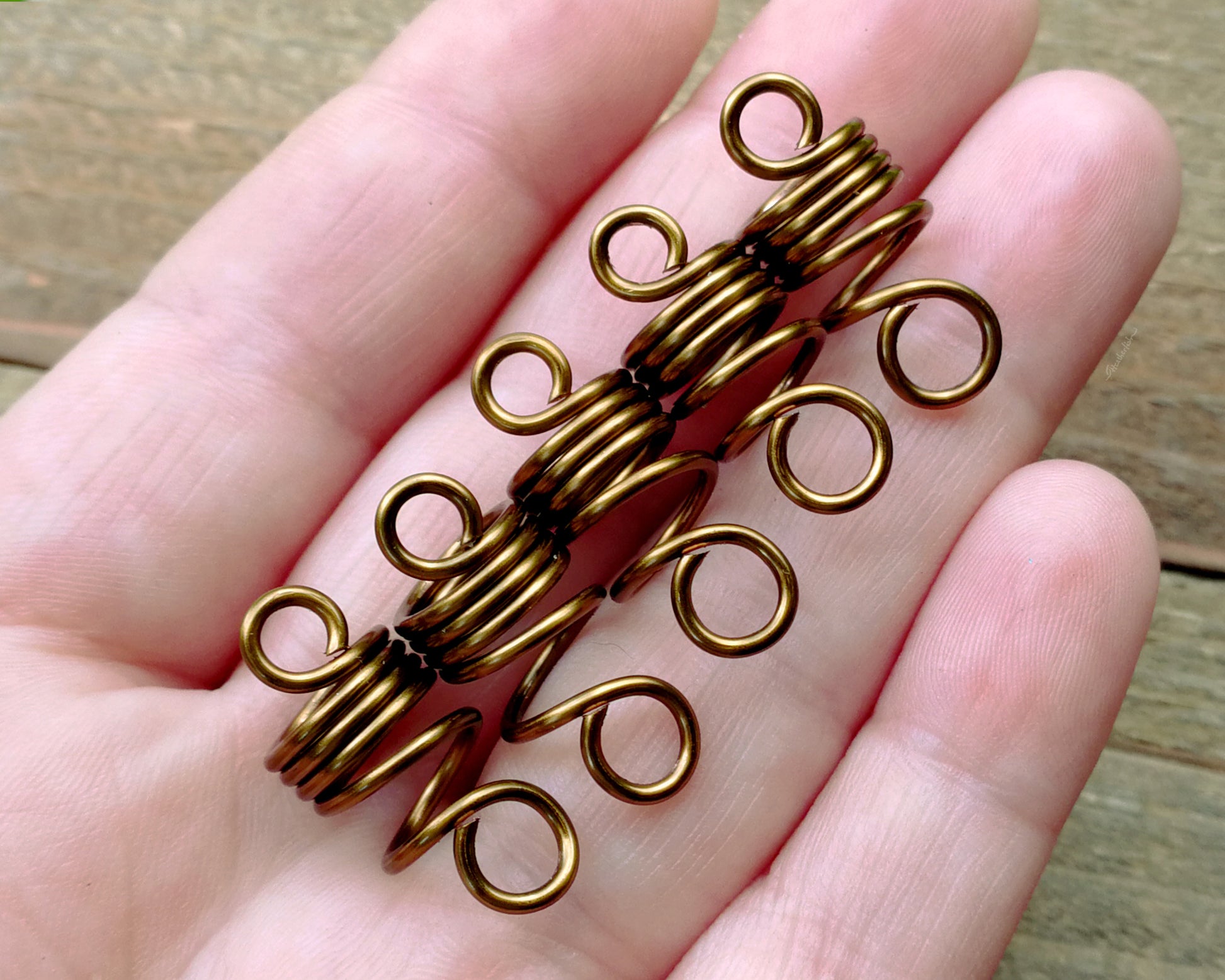Set of 5 filigree beads held in hand to show scale.
