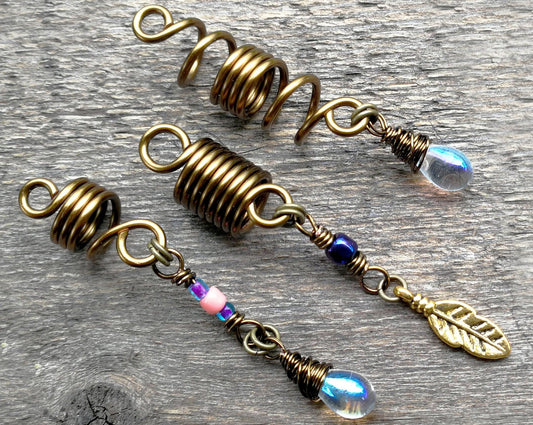 Set of 3 fall color dread beads on wood background.