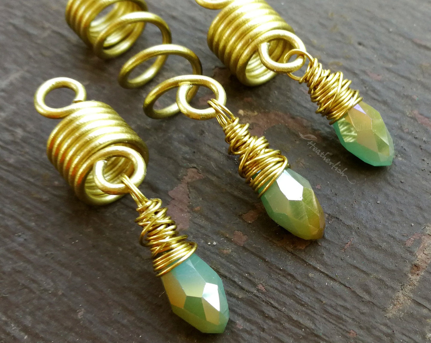 Light Blue, Gold Loc Beads, Set of 3 displayed on painted wood background.