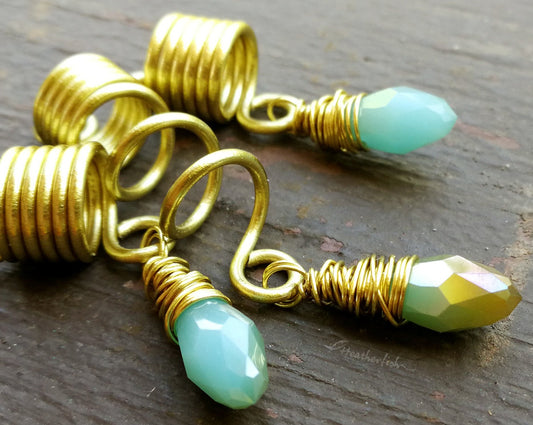 Light Blue, Gold Loc Beads, Set of 3 displayed on painted wood background.