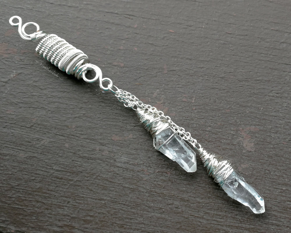 Top view of double quartz dread bead on weathered wood surface.