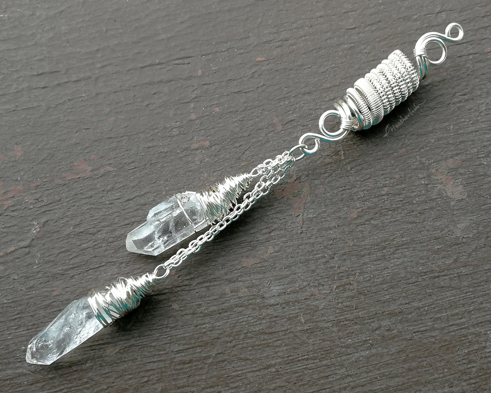 Top view of double quartz dread bead on weathered wood surface.