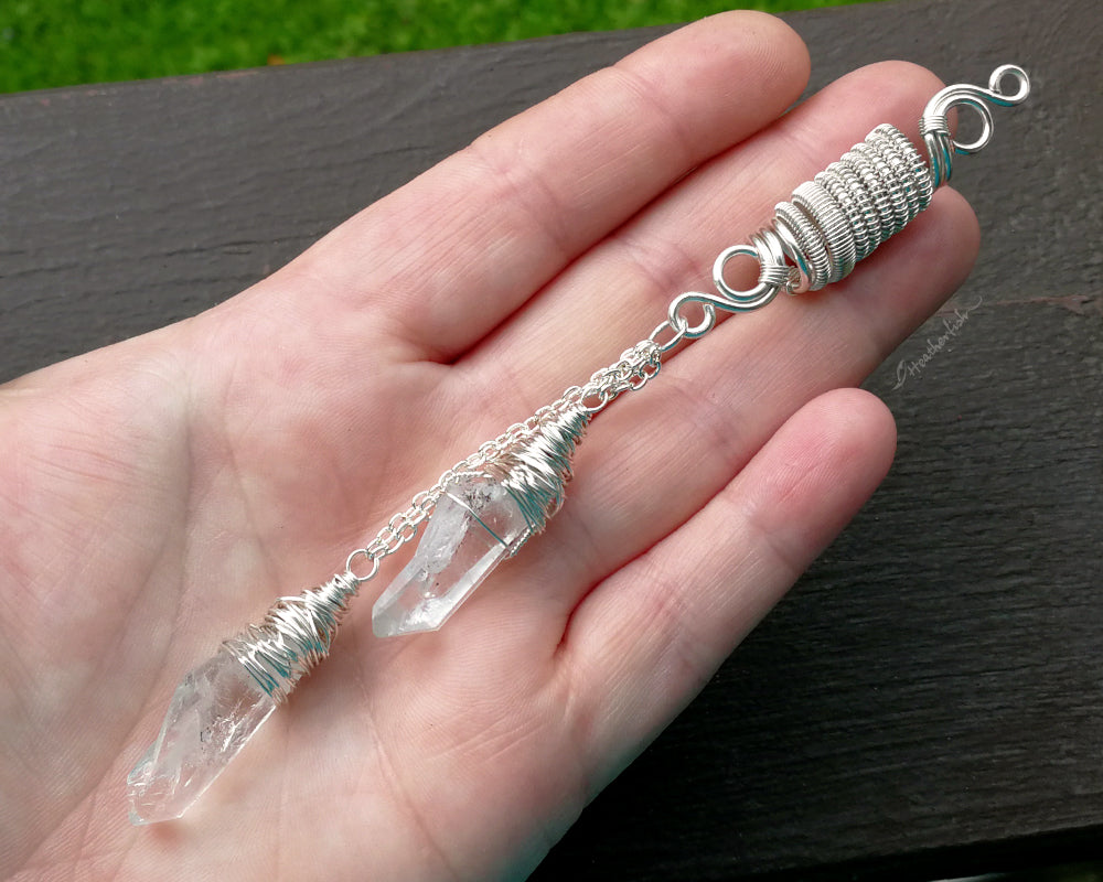 A double quartz dread bead in hand to show scale.