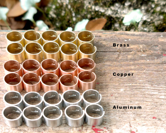 Photo showing all three metal types(Brass, Copper, Aluminum) on a wood background.