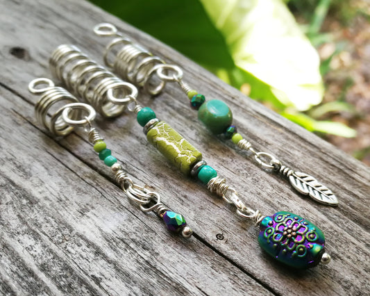 A close up view of Heatherfish Signature Dread Beads set of 3 on a wooden background.