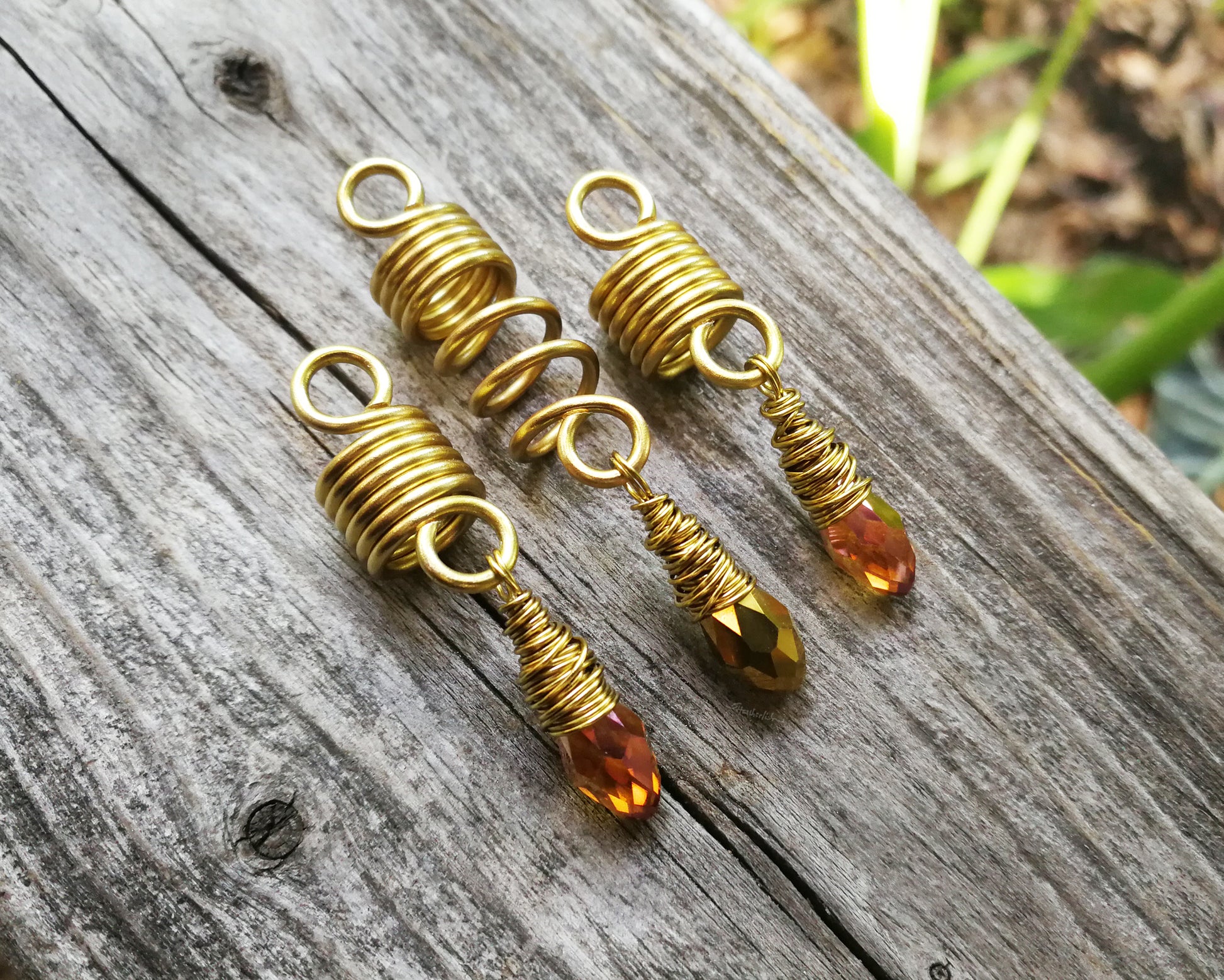 Amber and gold dread bead set of 3 displayed on wood background