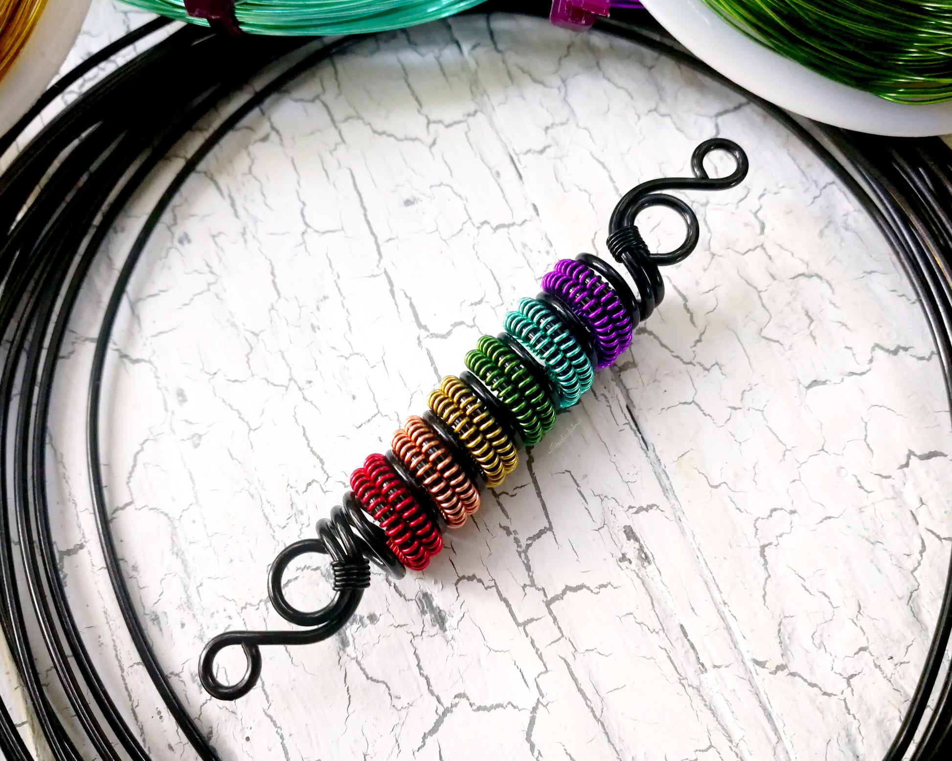 A top view of a Rainbow Pride Dread Bead.