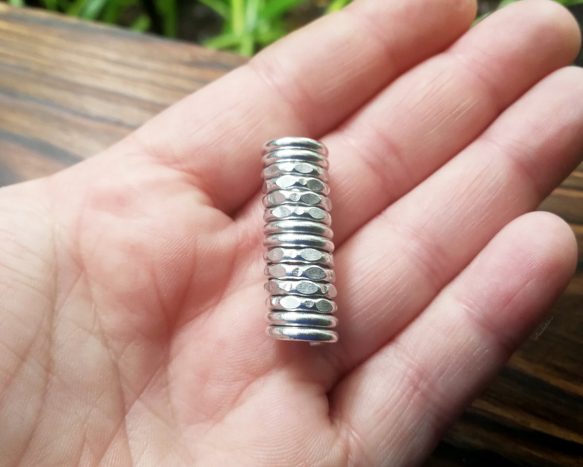 Textured dread bead in hand