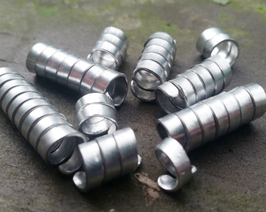 Set of 10 varied length aluminum dread beads in pile