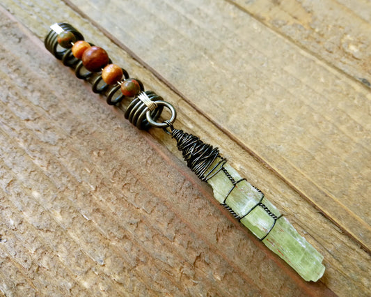 Green Kyanite, Hematite Dread Bead on wood background.