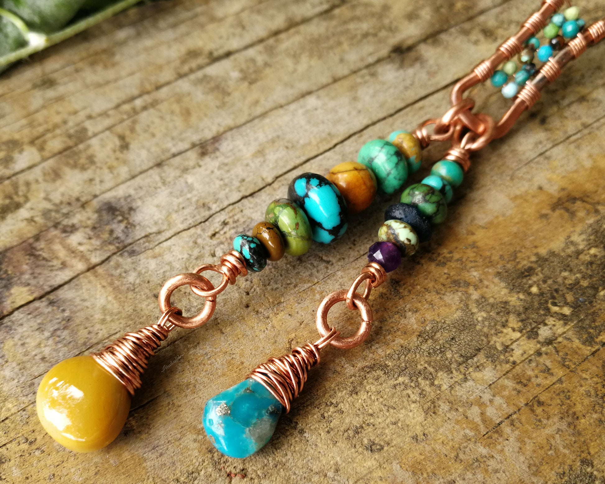 Yellow Jasper, Turquoise Dread Bead on a wood background.