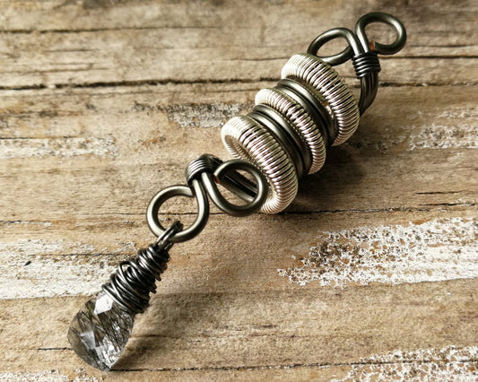 Two Tone Rutilated Quartz Dread Bead on wood background.