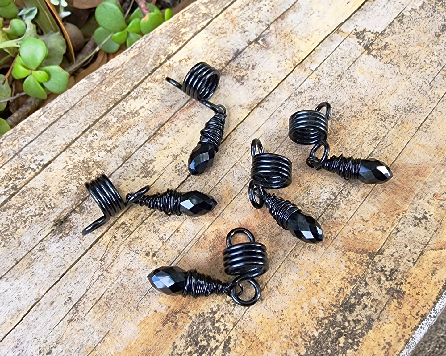 Black Glass Loc Beads, Set of 5 on wood background.