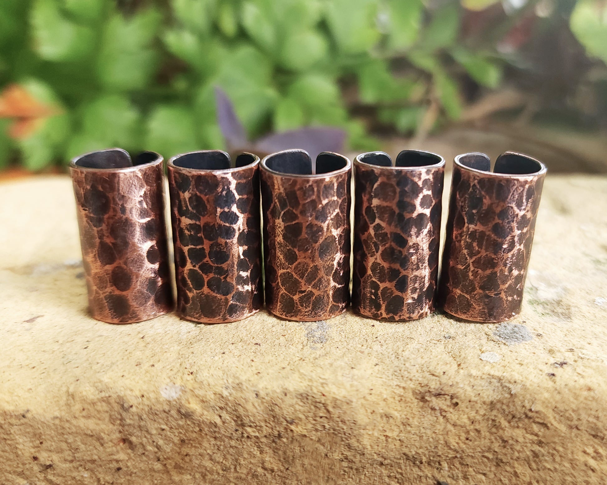 Textured Oxidized Copper Cuffs on a brick background.