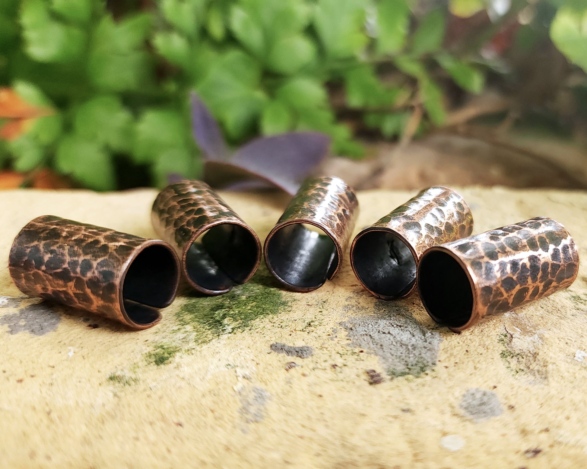 Textured Oxidized Copper Cuffs on a brick background.