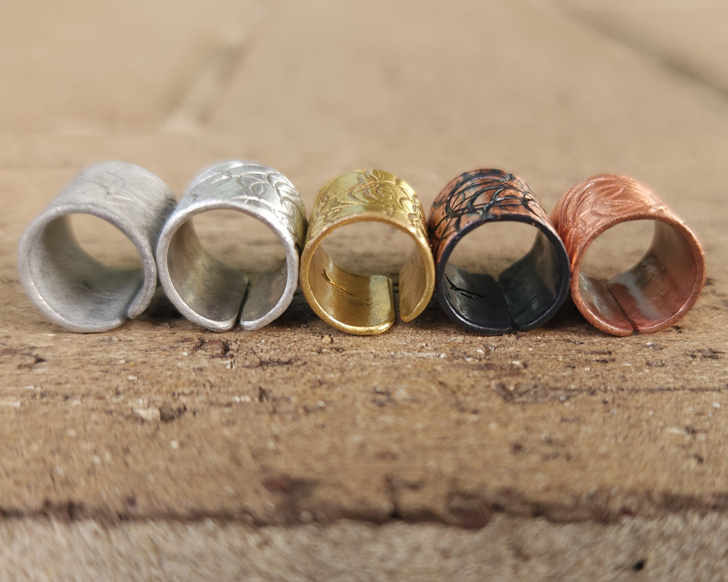 Textured hair cuff options on a brick background.