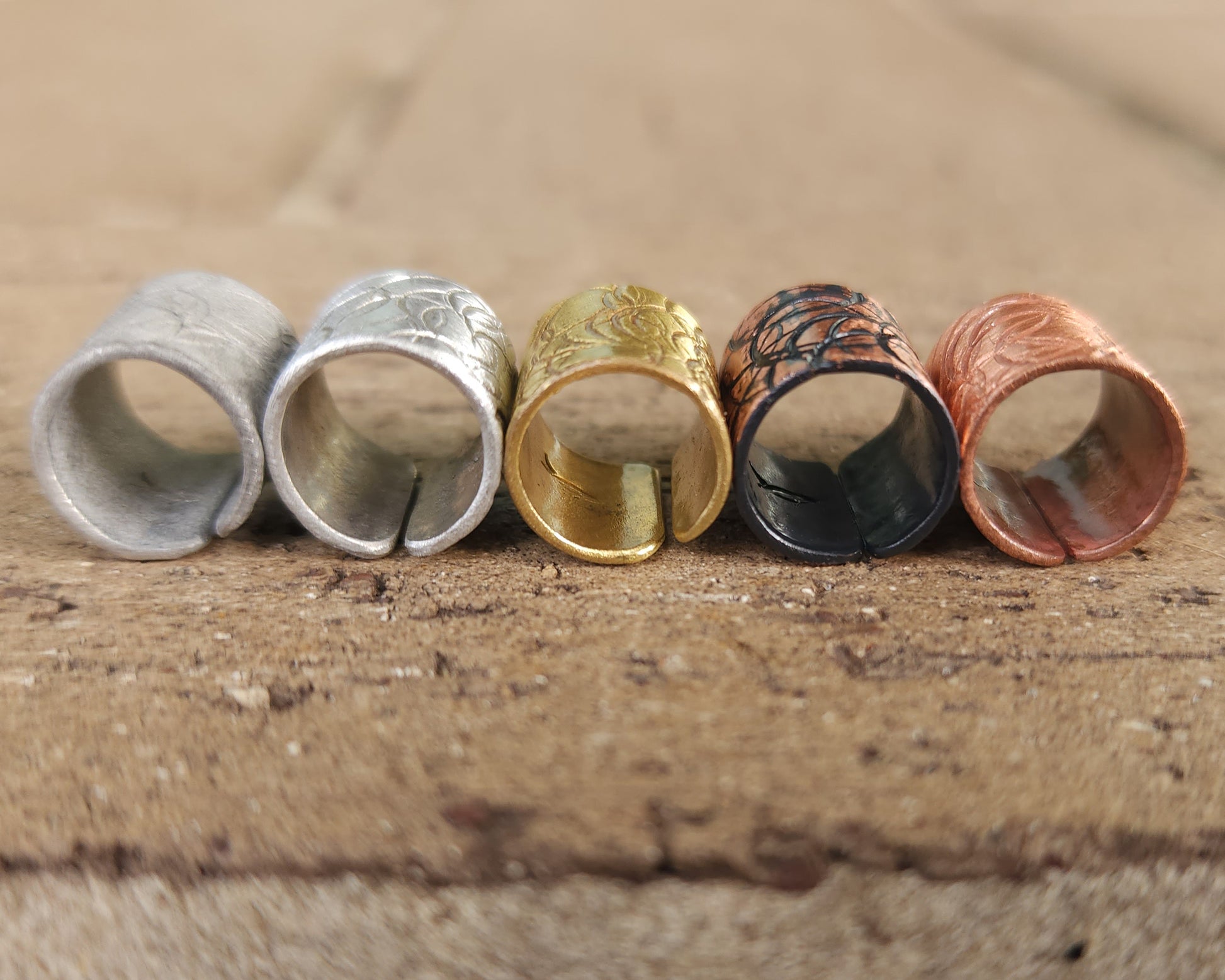 Textured hair cuff options on a brick background.