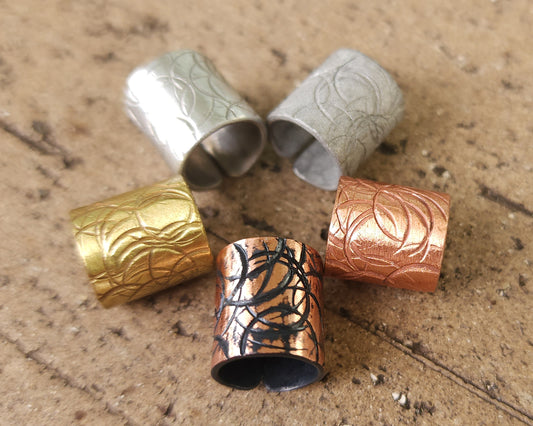 Textured hair cuff options on a brick background.