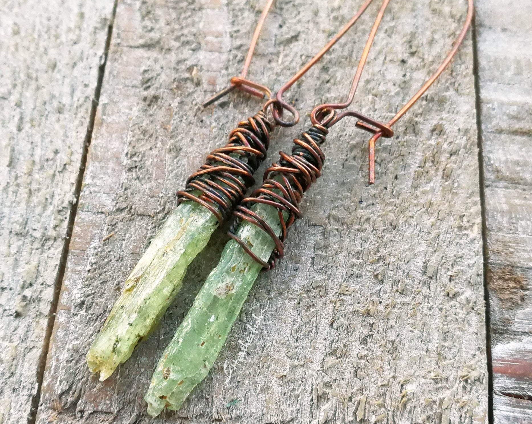 A top view of Green Kyanite Earrings wrapped in Oxidized Copper.
