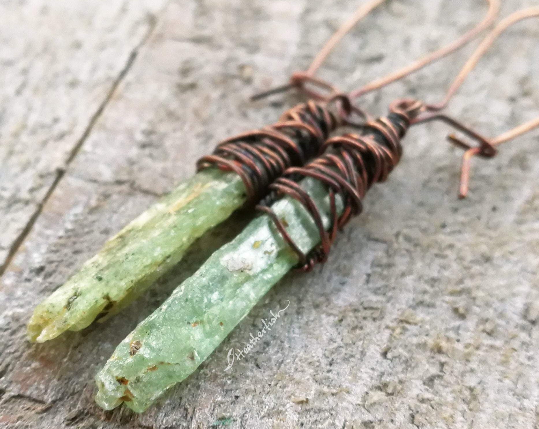 A side view of Green Kyanite Earrings wrapped in Oxidized Copper.