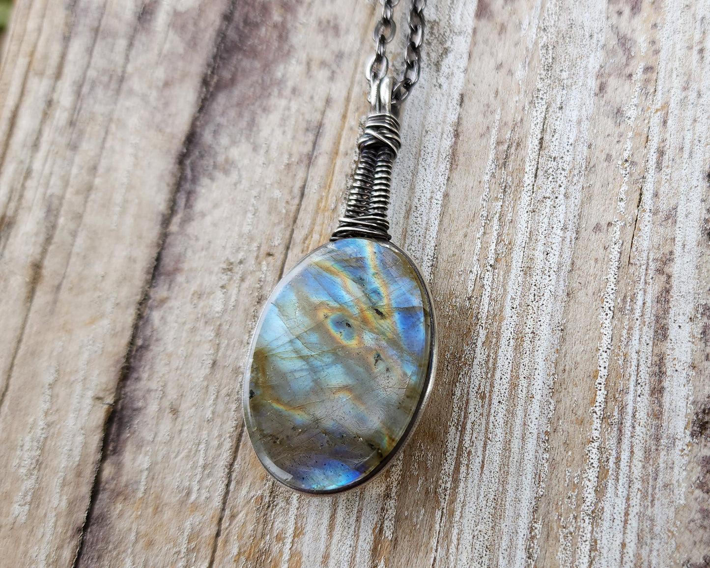 Blue Labradorite Pendant, Filled Silver on wood background.