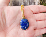 Lapis Lazuli Necklace, Gold Tone held in hand to show scale.