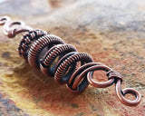 A side view of a Oxidized Copper Dread Bead.