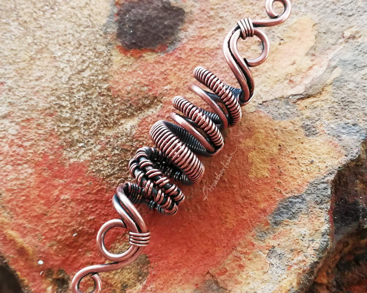 A top view of a Oxidized Copper Loc Bead.