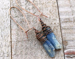 Top view pair of Blue Kyanite Earrings on a wooden background.