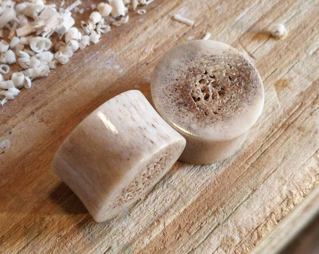 A close up detailed view of Handmade Antler Plugs.