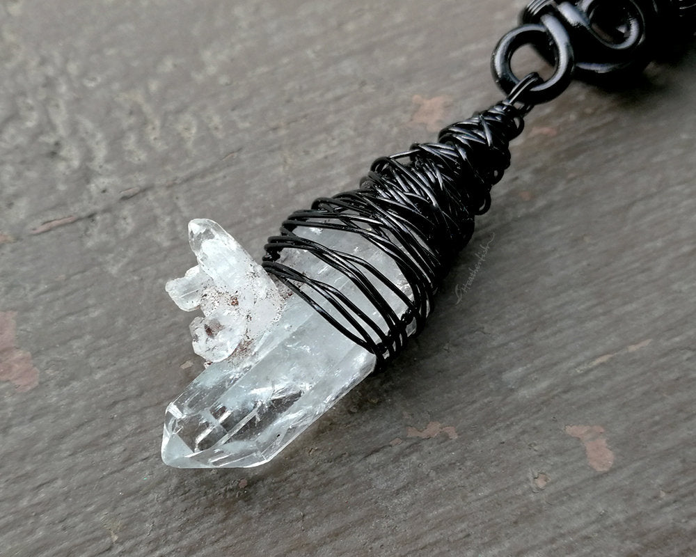 A close up view of a Woven Black Crystal Dread Bead.